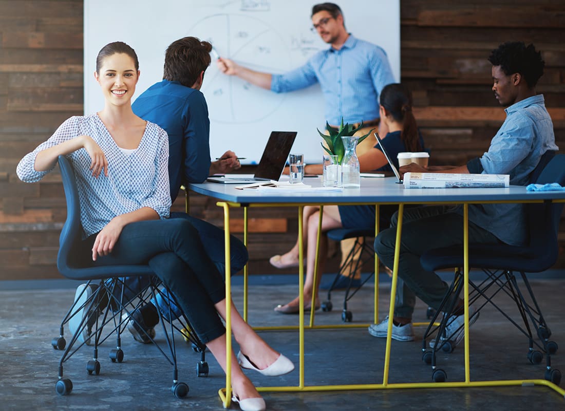 Insurance Solutions - Woman Smiling During a Business Meeting
